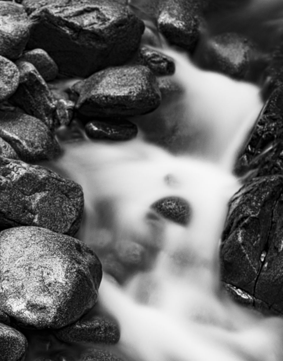 A mountain stream running over dark rocks