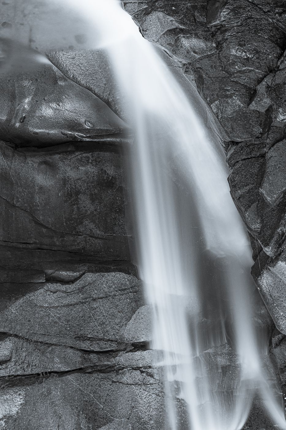A waterfall falling over a dark rock face